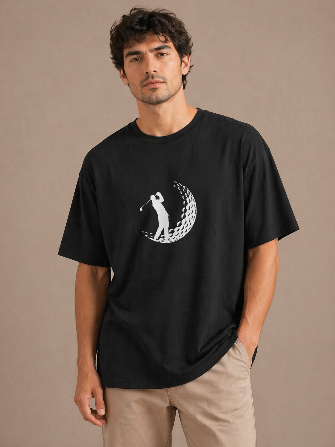Man wearing a black t-shirt with a graphic design on a beige background
