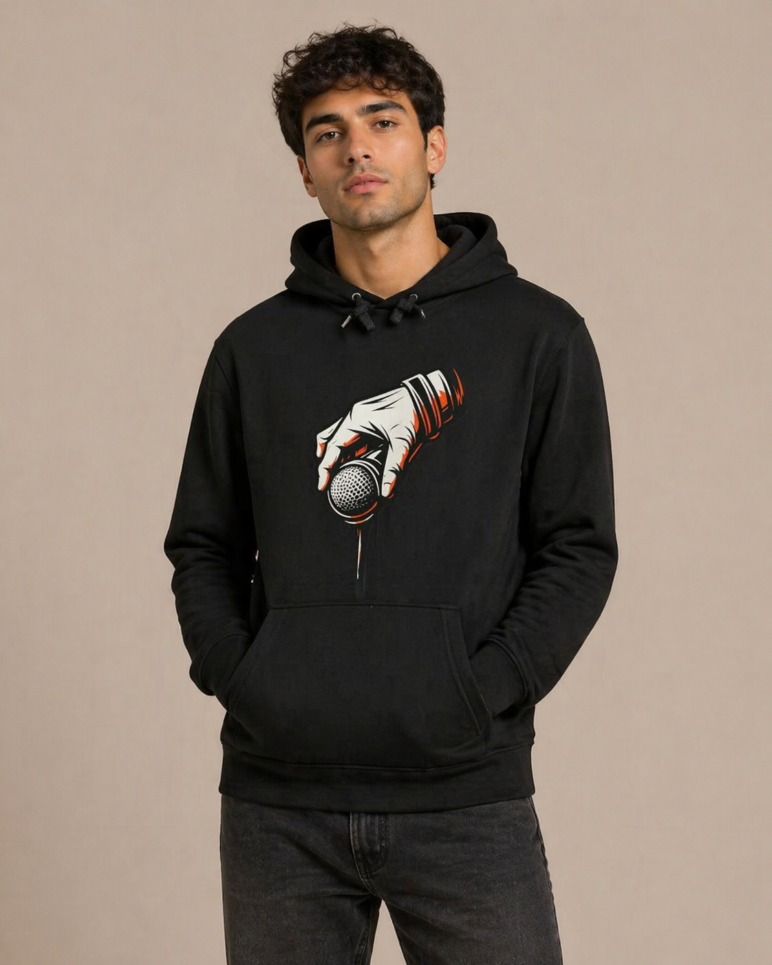 Person wearing a black hoodie with a graphic design on a beige background