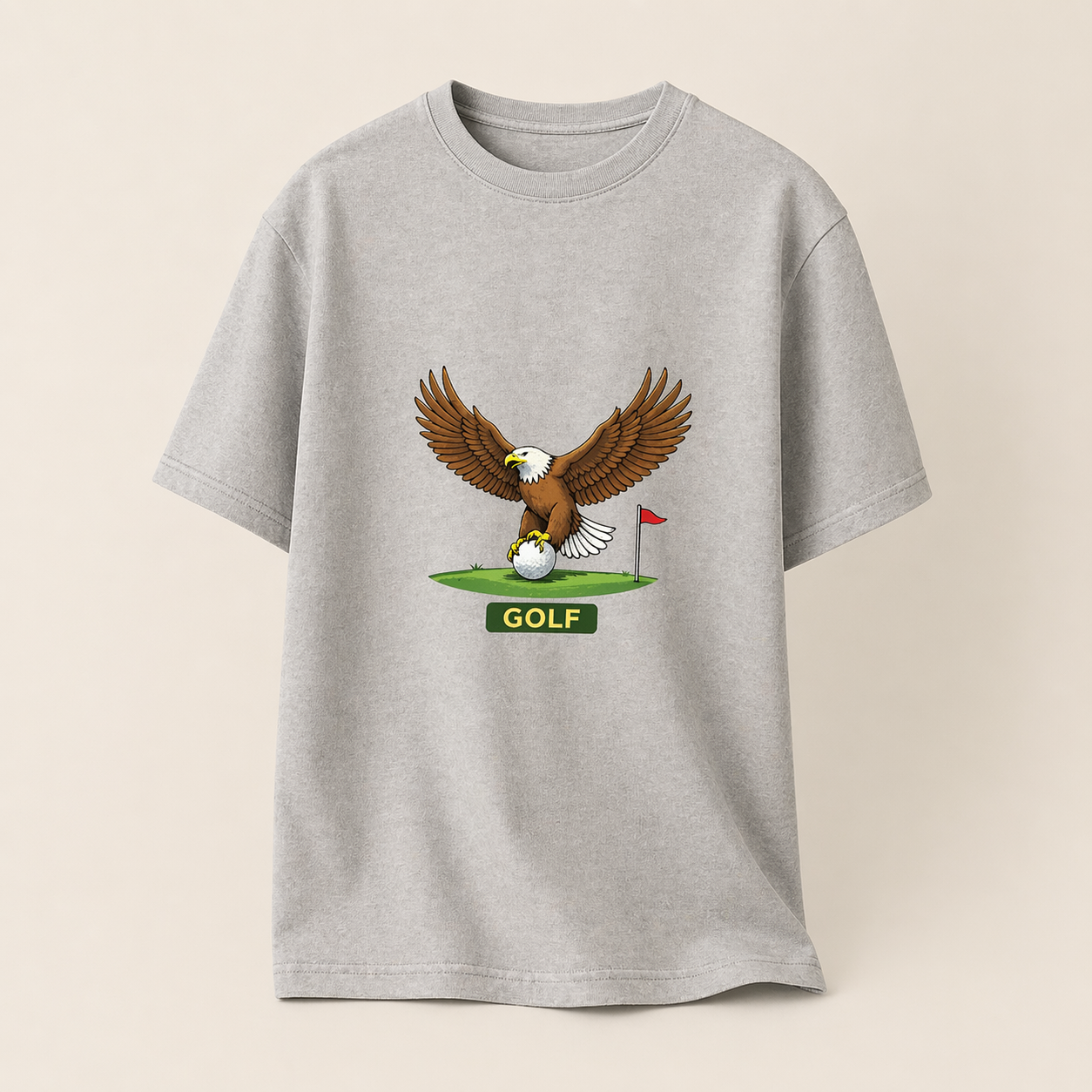 Gray t-shirt with an eagle and golf ball graphic on a beige background