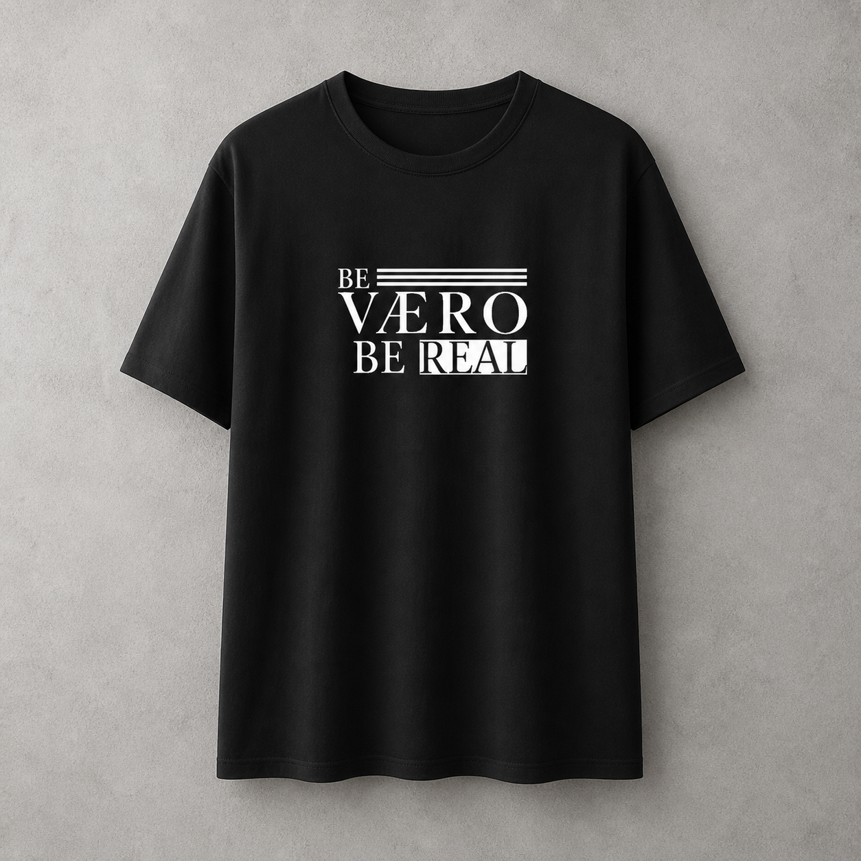 Black t-shirt with 'BE V×RO BE REAL' text on a gray background