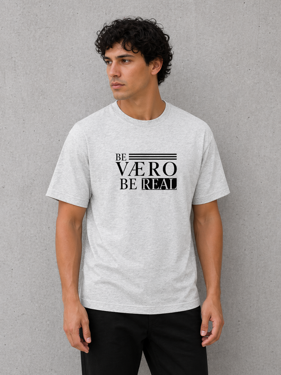 Man wearing a gray t-shirt with 'BE VAERO BE REAL' text on a gray background