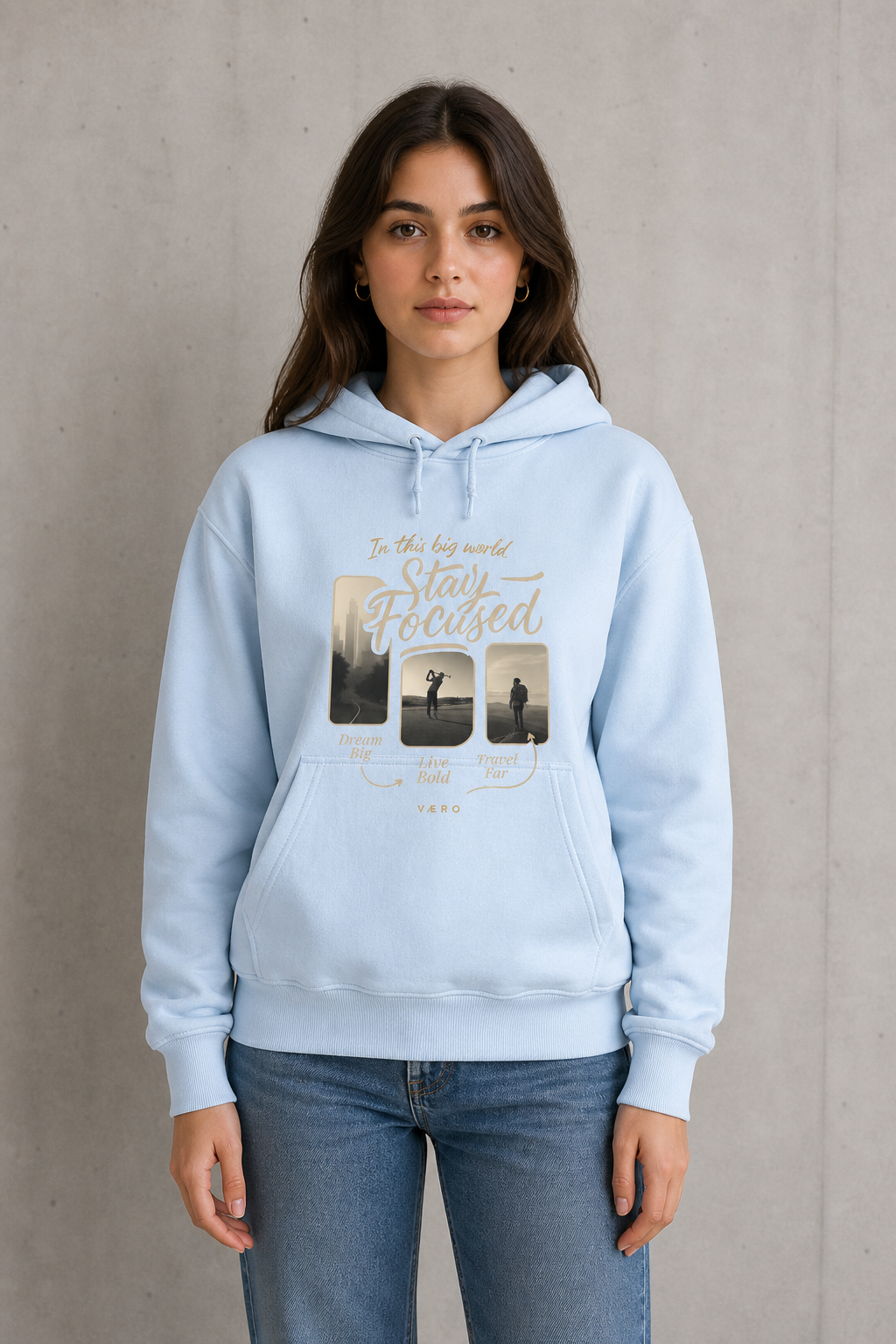 Woman wearing a light blue hoodie with printed design on a plain background