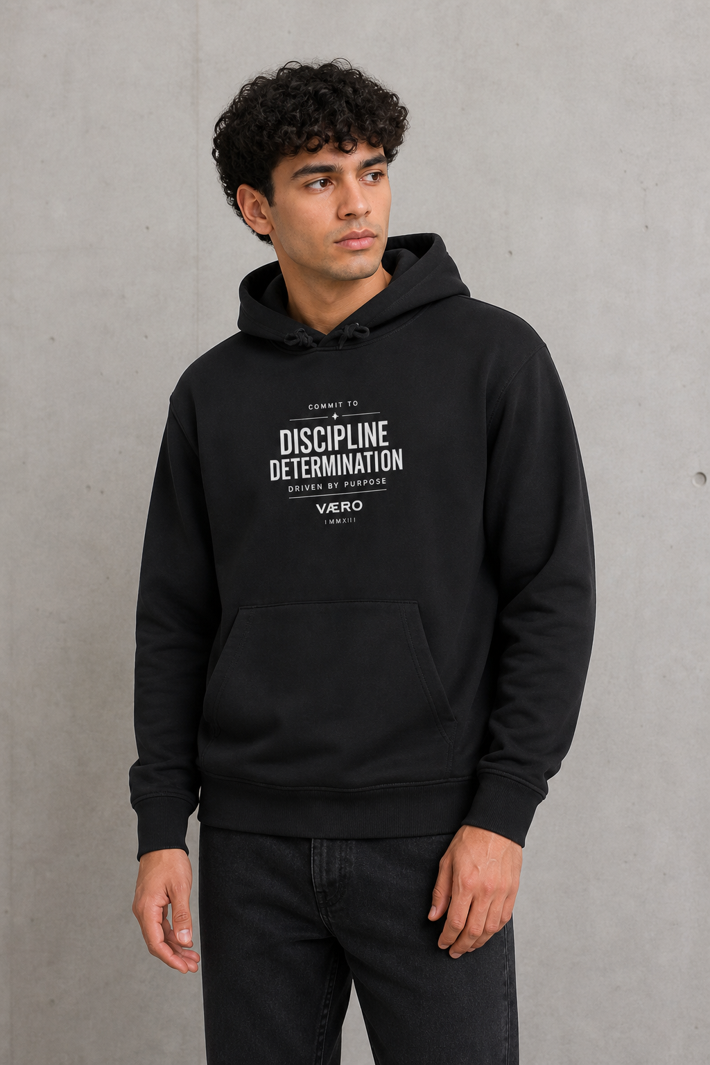 Person wearing a black hoodie with text on a gray background