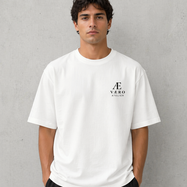 Man wearing a white t-shirt with a logo on a gray background