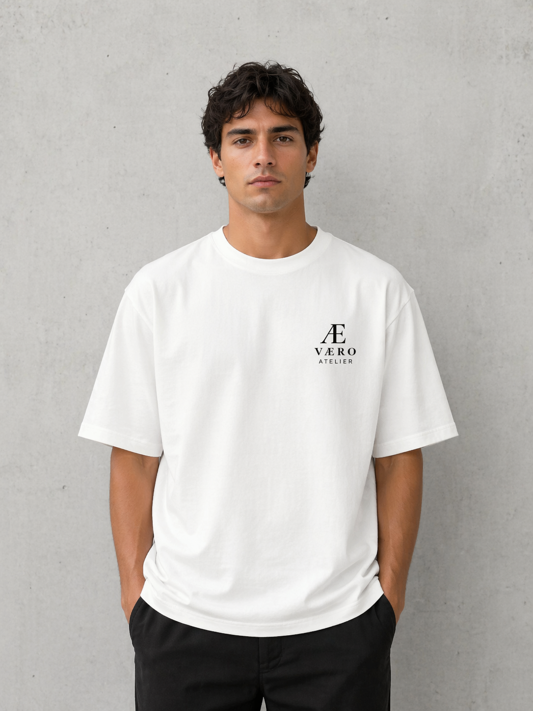 Man wearing a white t-shirt with a logo on a gray background