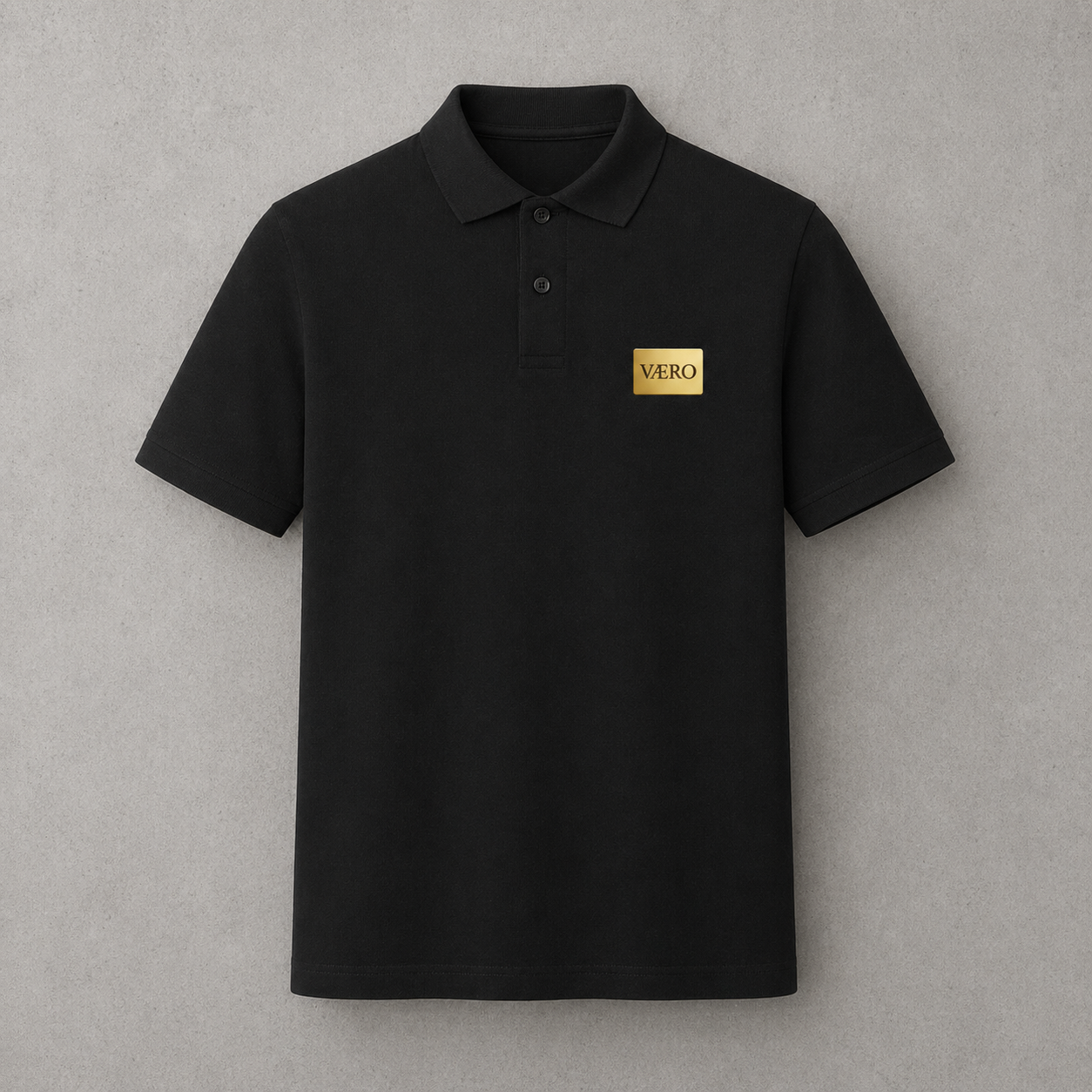 Black polo shirt with a gold logo on a gray background