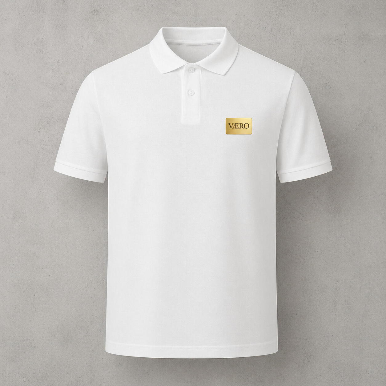 White polo shirt with a gold logo on a gray background