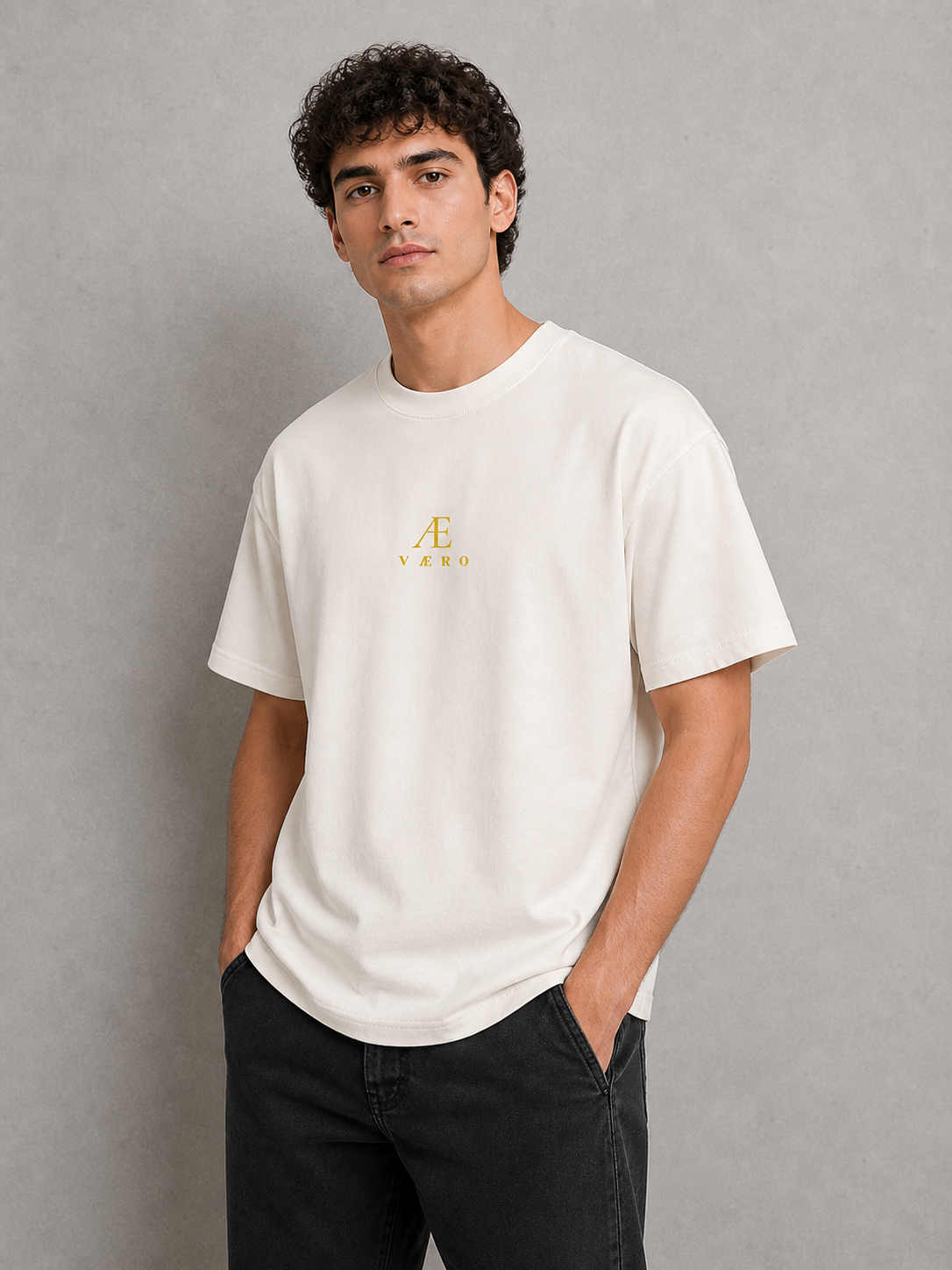 Man wearing a white t-shirt with a logo on a gray background