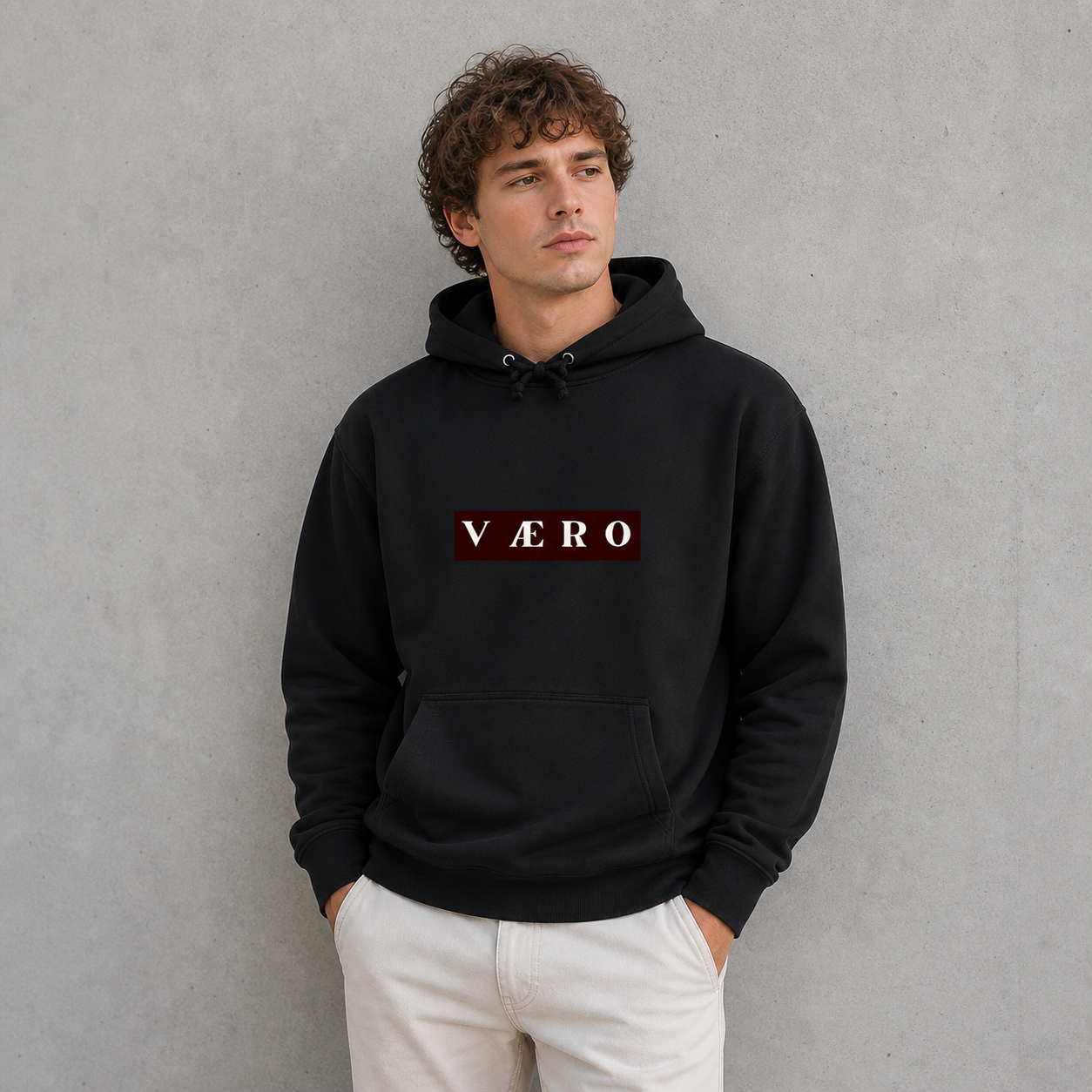 Man wearing a black hoodie with 'VAERO' logo against a gray background