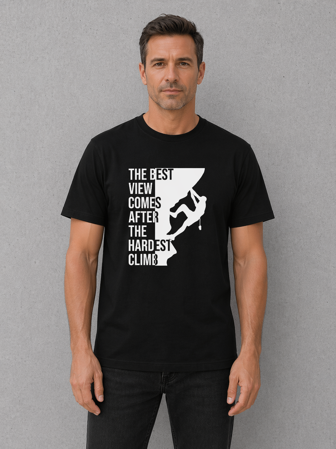 Man wearing a black t-shirt with a motivational graphic and text on a gray background