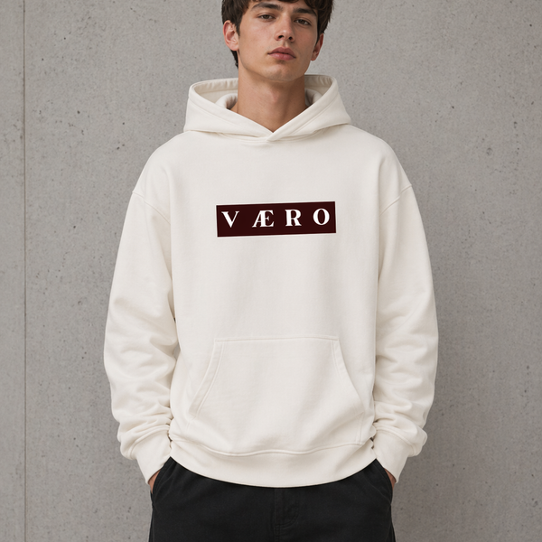 Person wearing a white hoodie with 'VAERO' logo against a gray background