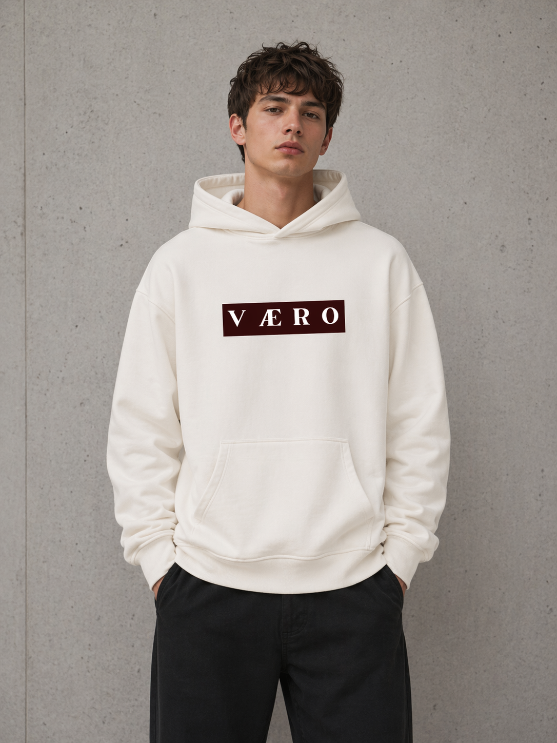 Person wearing a white hoodie with 'VAERO' logo against a gray background
