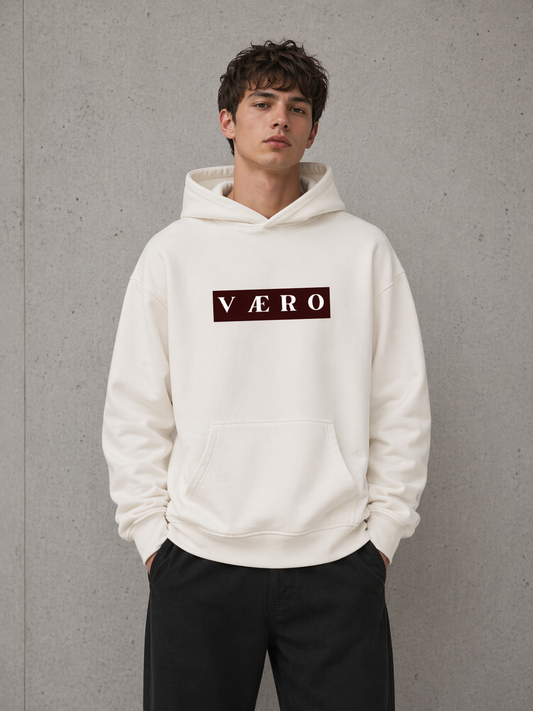 Person wearing a white hoodie with 'VAERO' logo against a gray background