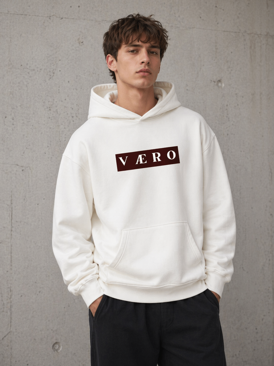Person wearing a white hoodie with 'VAERO' logo against a gray background