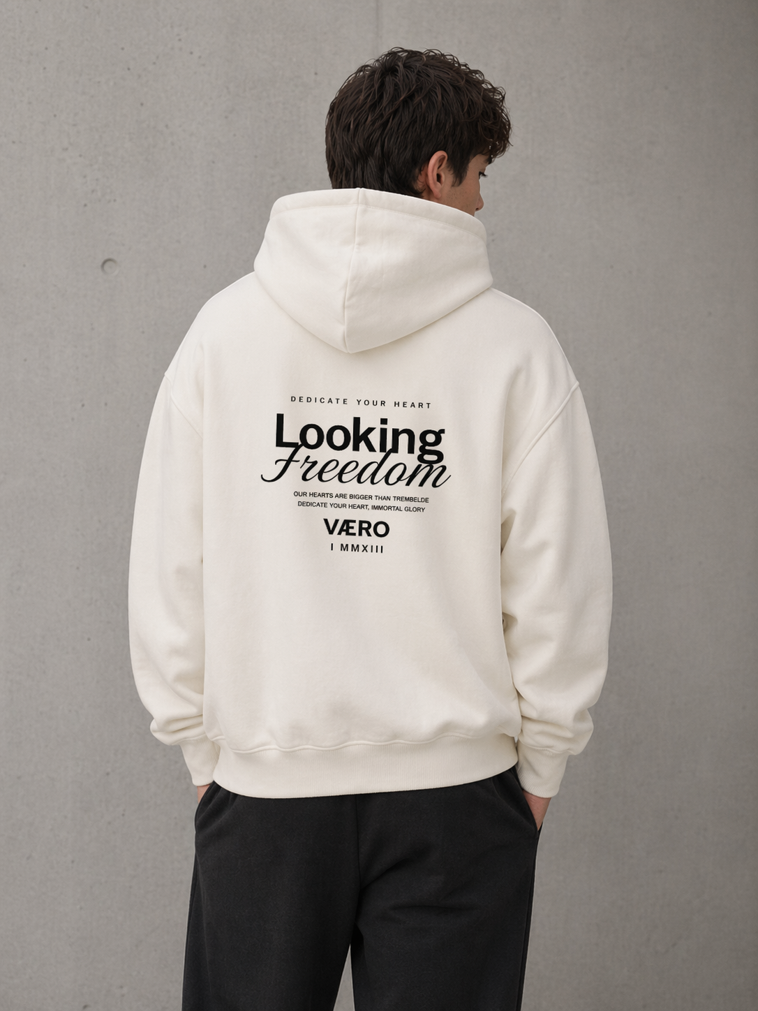 Person wearing a white hoodie with text on the back against a gray background
