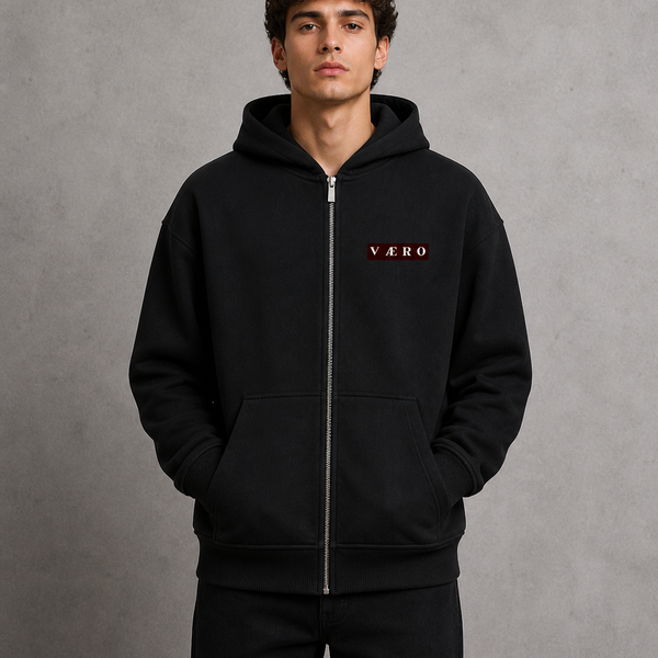 Person wearing a black hoodie with 'VAERO' branding on a gray background
