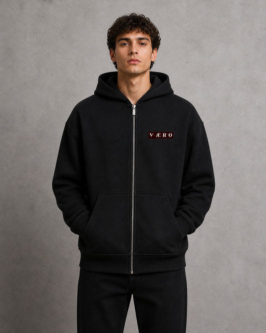 Person wearing a black hoodie with 'VAERO' branding on a gray background