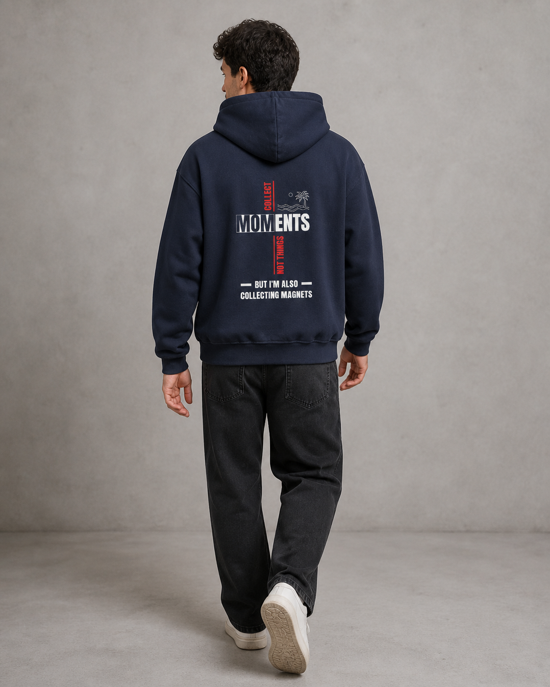 Person wearing a navy hoodie with text on the back against a gray background