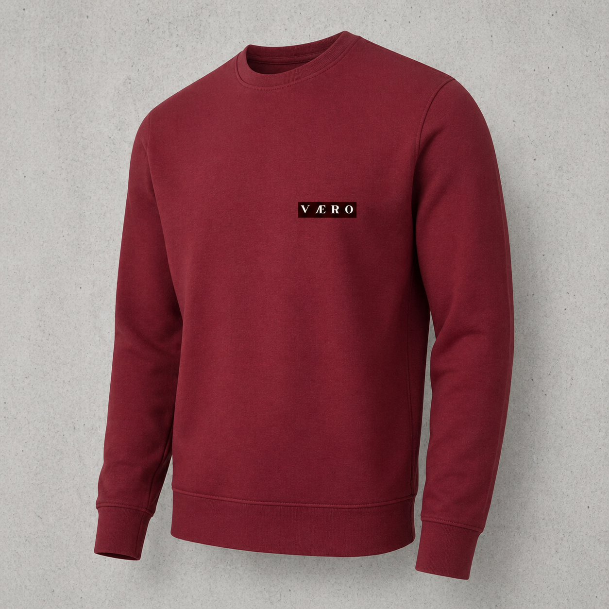 Maroon sweatshirt with a logo on a gray background