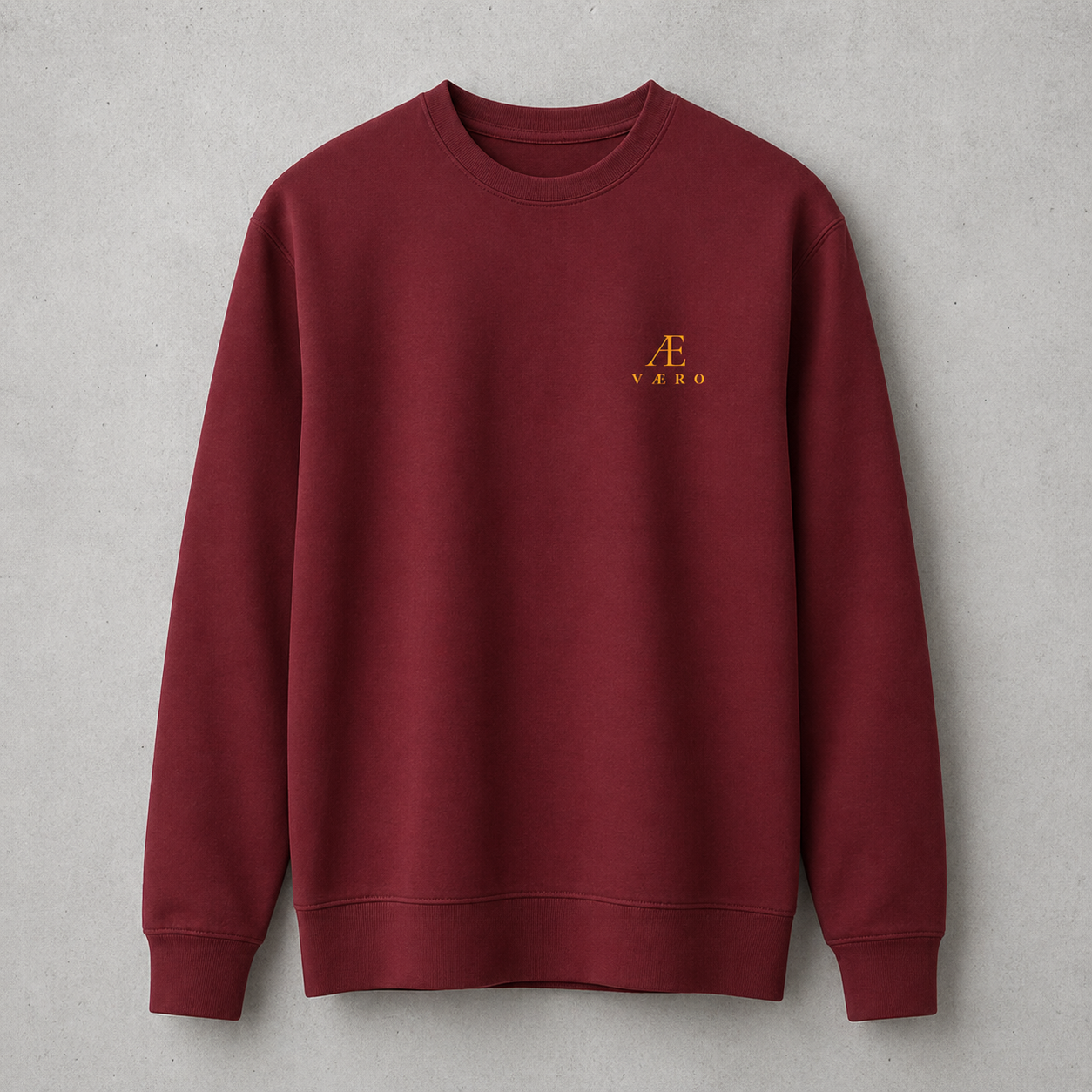 Maroon sweatshirt with a logo on a gray background