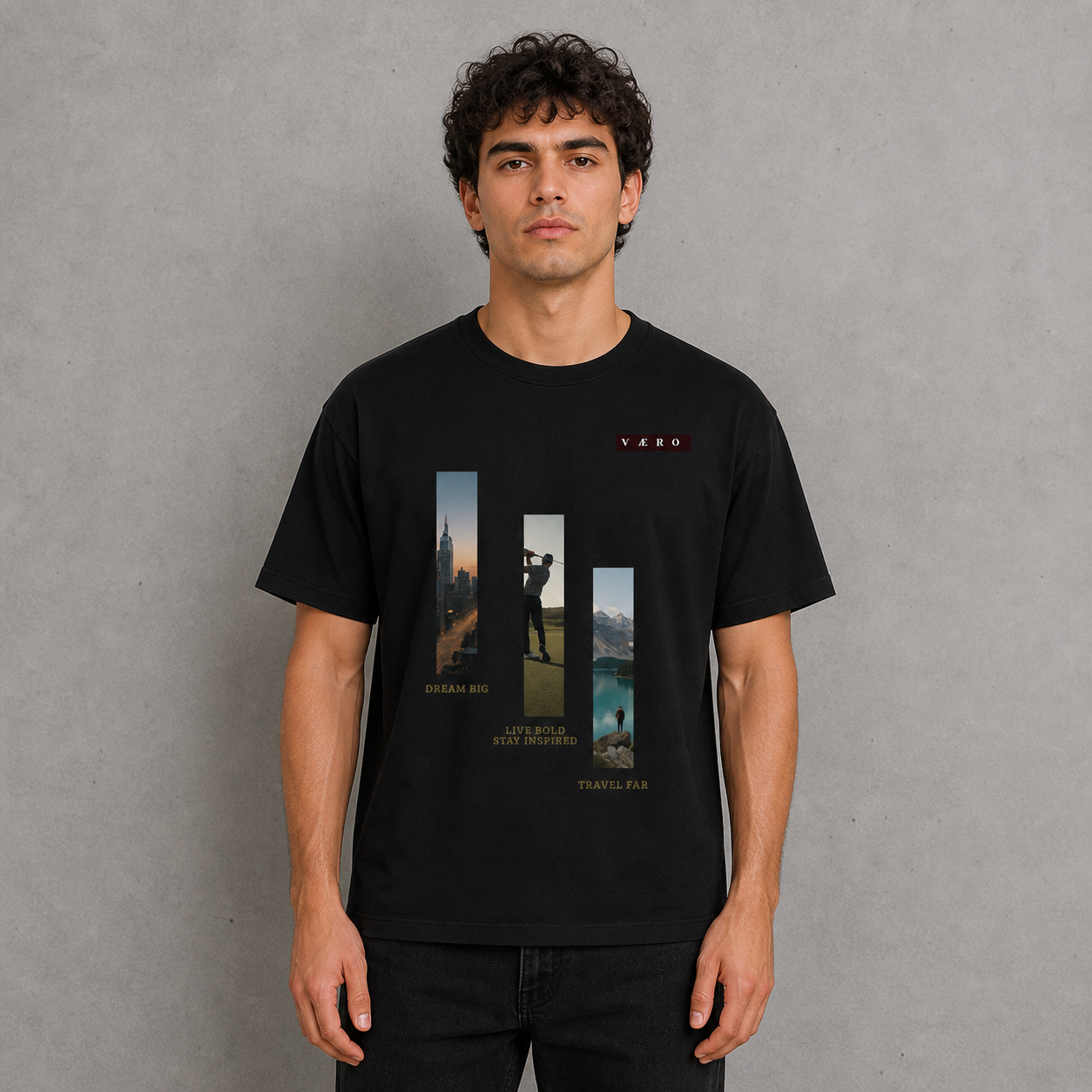 Man wearing a black t-shirt with graphic designs and text on a gray background