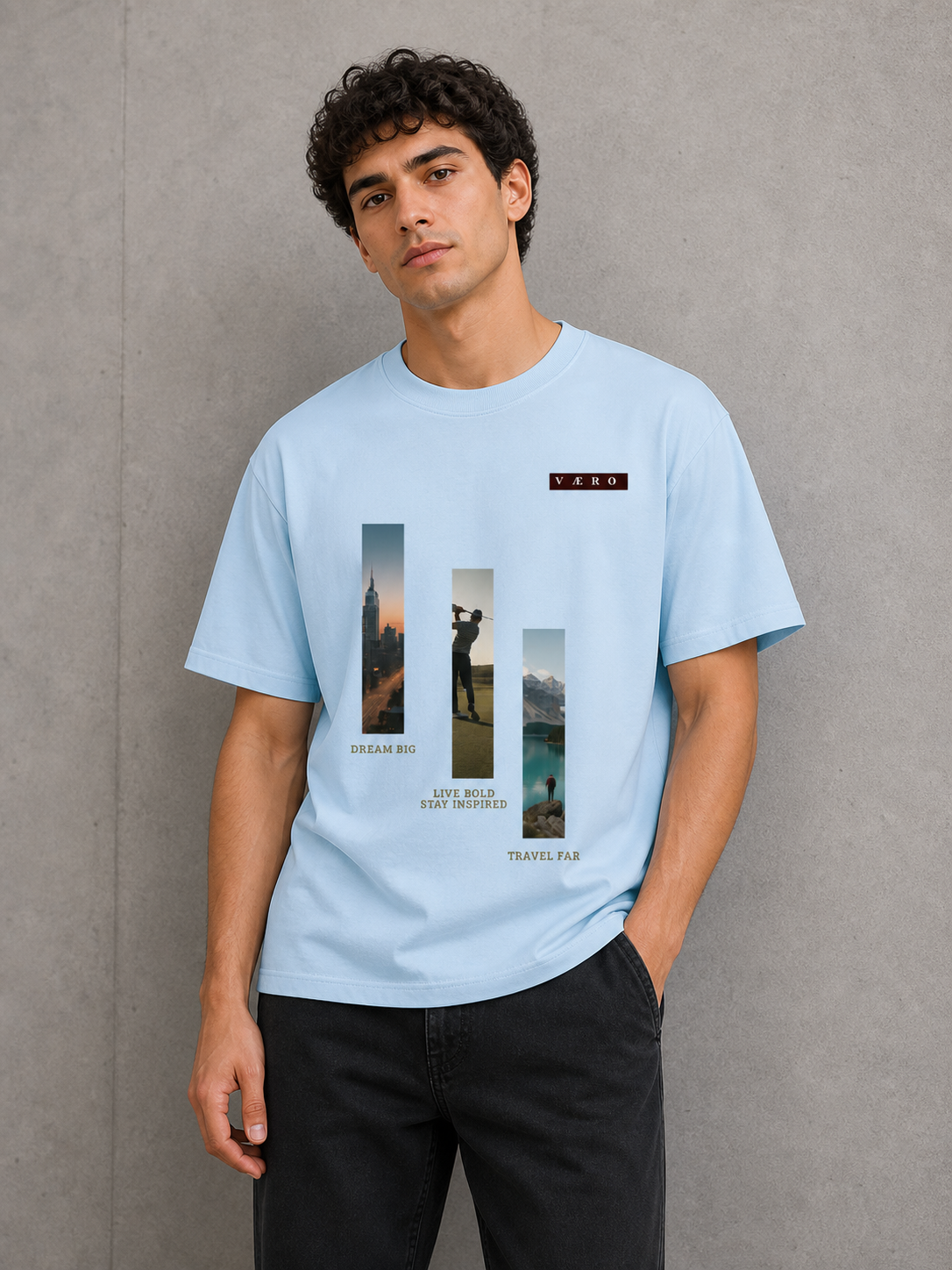 Person wearing a light blue t-shirt with graphic designs and text against a gray background