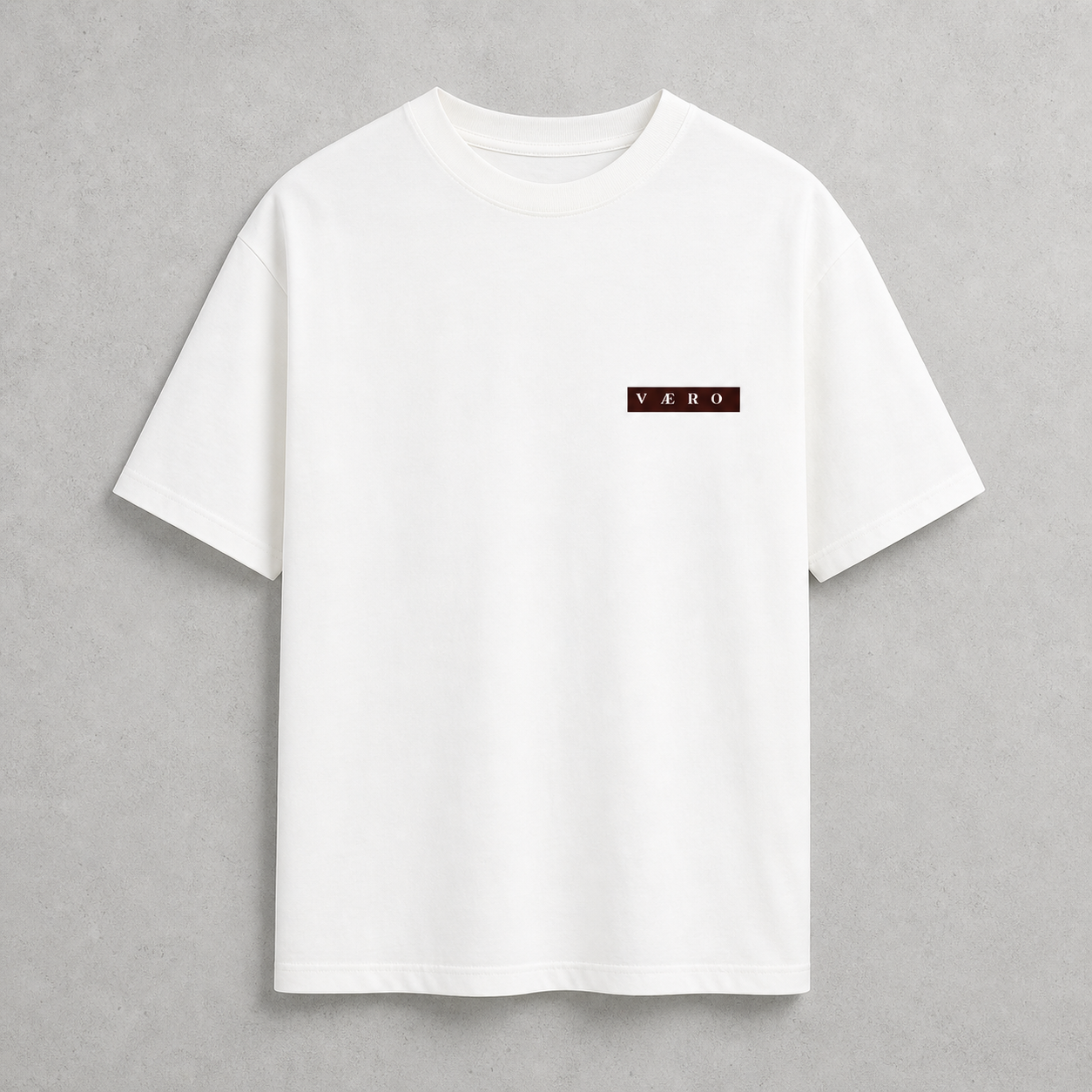 White t-shirt with a small logo on a gray background