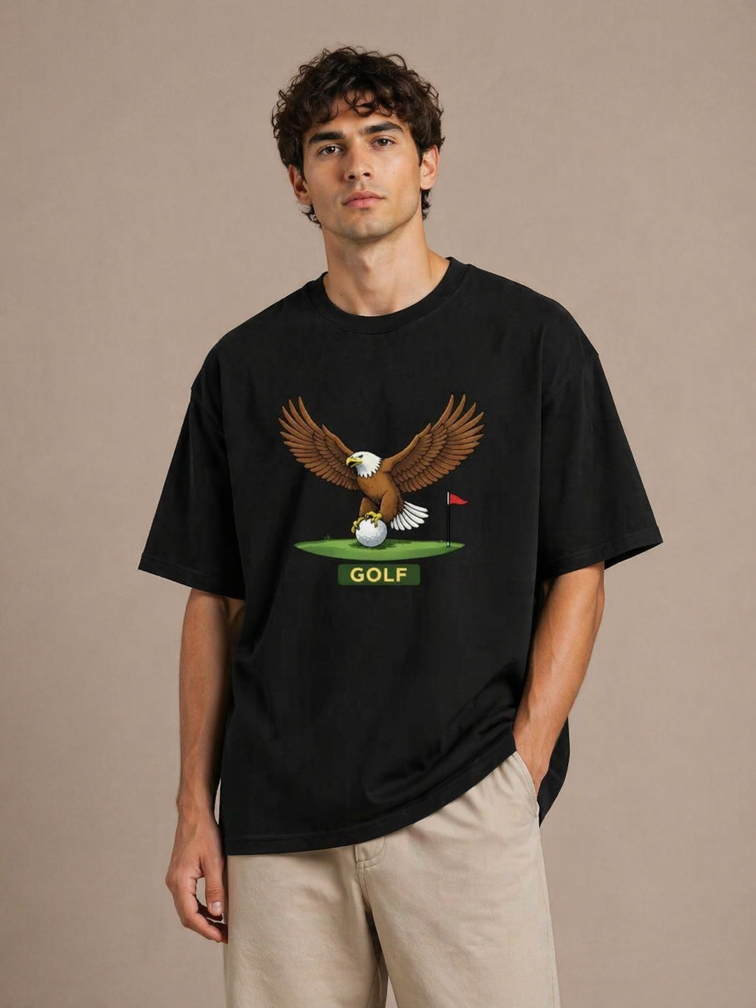 Person wearing a black t-shirt with an eagle graphic and 'GOLF' text on a beige background