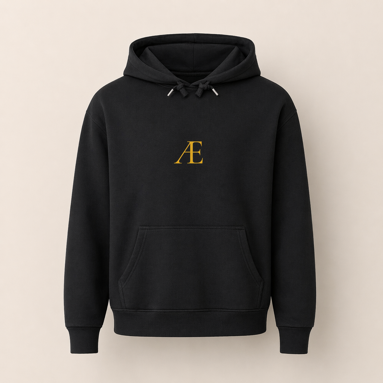 Black hoodie with a gold logo on a beige background