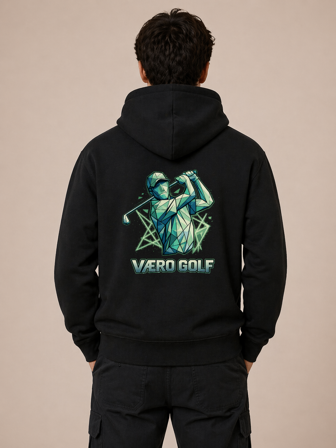 Person wearing a black hoodie with 'Vero Golf' design on the back against a beige background